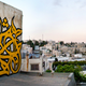 Image for article titled Photos: A “calligraffiti” artist tags buildings with beautiful Arabic calligraphy